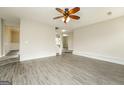 Spacious open living area with modern flooring and staircase to the upper level at 3675 Arminto Dr, Ellenwood, GA 30294