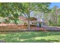 Traditional home featuring covered porch, pavilion, and mature trees, creating a serene and private outdoor living space at 40 Butler Bridge Dr, Mcdonough, GA 30252