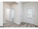 Entryway with wood-look floors, white walls, trim, and doors leading to various rooms at 299 Limestone Circle, Conyers, GA 30013