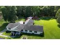 Sprawling ranch-style home featuring an attached garage, lush lawn and wooded surroundings at 395 Moss Ferry Rd, Villa Rica, GA 30180