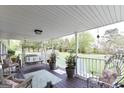 Covered front porch with swing, seating and garden views is perfect for relaxation at 395 Moss Ferry Rd, Villa Rica, GA 30180