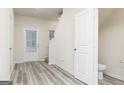 Inviting entryway with vinyl floors, a nearby powder room, and access to the staircase at 307 Limestone Circle, Conyers, GA 30013