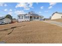 Street view of a cozy home with a well-kept lawn, a charming front porch, and a convenient driveway at 6324 Amberly Rd, Rex, GA 30273