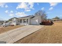 View of home with driveway leading to the attached garage, solar panels, and a welcoming front porch at 6324 Amberly Rd, Rex, GA 30273