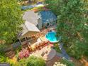 Aerial view showcasing a backyard with an above-ground pool and a spacious wooden deck at 203 Silverwood Way, Peachtree City, GA 30269
