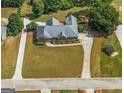 A captivating aerial view of a home displaying its circular driveway and large, landscaped yard at 103 Wisteria Way, Stockbridge, GA 30281