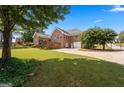 A spacious backyard with green grass, a wooden fence and plenty of room to enjoy outdoor activities at 103 Wisteria Way, Stockbridge, GA 30281