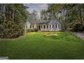 Charming single-story home with a well-manicured lawn and a welcoming red front door at 185 Cold Harbor Ct, Sharpsburg, GA 30277