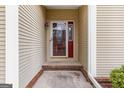 Covered front entry featuring a decorative glass front door and sidelight with a brick step at 210 Brittany Chase, Fayetteville, GA 30214