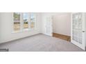 Bright office space with natural light, french doors, and neutral carpeting at 7260 Eton Ln, Locust Grove, GA 30248