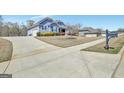 Long driveway leading to a charming home with a well-maintained lawn and mature trees at 270 Blue Point Pkwy, Fayetteville, GA 30215