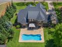 Aerial view of a private backyard oasis with in-ground pool and lush landscaping at 249 Suffolk Way, Mcdonough, GA 30252