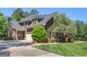 Spacious home featuring a stone chimney, 3-car garage, and mature landscaping at 249 Suffolk Way, Mcdonough, GA 30252