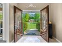 Inviting front door of a beautiful home, framed by lush greenery and a well-manicured lawn at 105 Hartford Pl, Fayetteville, GA 30214