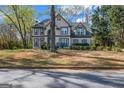 Charming two-story home with neutral siding, trimmed windows, mature landscaping, and a classic architectural style at 3139 Players Dr, Jonesboro, GA 30236