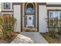 A classic white front door framed by columns and a charming wreath welcomes you to the home at 3139 Players Dr, Jonesboro, GA 30236