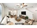 Virtually staged living room boasts an open floor plan, hardwood floors, and recessed lighting for a modern feel at 4437 Ben Hill Rd, Atlanta, GA 30349