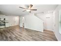Bright living room featuring new floors, fresh paint, and a modern ceiling fan with easy access to the stairs at 4437 Ben Hill Rd, Atlanta, GA 30349