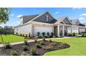 Well-maintained home with manicured lawn, landscaping, two-car garage and brick and siding exterior at 591 Parnassus Rd, Locust Grove, GA 30248