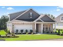 Well-maintained home with manicured lawn, landscaping, two-car garage and brick and siding exterior at 591 Parnassus Rd, Locust Grove, GA 30248