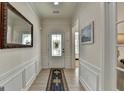 Elegant entryway featuring decorative moldings, a stylish mirror, and a beautiful patterned rug at 4230 Braden Ln, Kennesaw, GA 30041