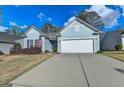Well-maintained single-Gathering home with a wide driveway, two-car garage, and manicured lawn at 4230 Braden Ln, Kennesaw, GA 30041