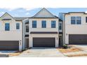 Modern townhome with a gray garage door and white painted brick at 1022 Sutherland Lane # 42, Lawrenceville, GA 30043