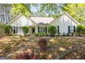 Traditional style home with manicured bushes and shade trees at 12843 Simmons Rd, Hampton, GA 30228