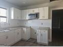 Updated kitchen featuring white cabinets, stainless steel appliances, and modern countertops at 674 Jett Nw St, Atlanta, GA 30318