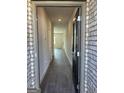 Inviting hallway with wood-look flooring, neutral walls, and an open view into the home at 5360 Tolar Rd # 72, South Fulton, GA 30213