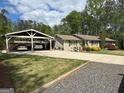 Beautiful house with a charming carport and a well-maintained lawn at 363 Palmetto Rd, Tyrone, GA 30290