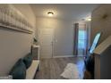 Bright entryway featuring modern decor, a stylish mirror, and durable flooring at 6539 Saint Mark Way, Fairburn, GA 30213