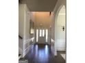 Bright and inviting foyer features hardwood floors, soaring ceilings, and elegant wainscoting at 160 Elysian Dr, Fayetteville, GA 30214