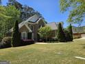 Beautiful two-story brick home with a manicured lawn, mature trees, and well-maintained landscaping at 45 Anna Dr, Covington, GA 30014