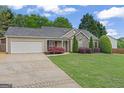 Well-maintained single-story home with a two car garage and beautiful front lawn at 421 Bear Cub Path, Social Circle, GA 30025
