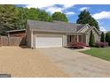 Beautiful single-story home with a well-manicured front yard and two car garage at 421 Bear Cub Path, Social Circle, GA 30025