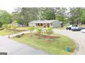 Charming ranch-style home with long driveway, complemented by well-maintained landscaping, and a basketball hoop at 140 Stoneview Cir, Covington, GA 30016