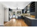 Stylish kitchen boasts stainless steel appliances, dark cabinetry, and hardwood floors at 180 Paces Dr, Fayetteville, GA 30215