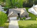 Bird's eye view of a brick home with a well-maintained lawn and driveway in a suburban neighborhood at 327 Viceroy Curv, Stockbridge, GA 30281