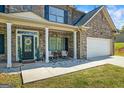Charming front porch with seating area, perfect for enjoying the outdoors at 634 Gardner Rd, Stockbridge, GA 30281