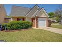 Charming single Gathering home with a one car garage and a well maintained lawn at 20 Highgate Trl, Covington, GA 30016