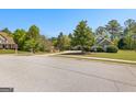 Attractive home with well-kept landscaping and verdant trees providing a tranquil and picturesque curb appeal at 202 Willow Rock Pt, Fayetteville, GA 30215