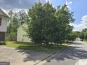 Spacious yard with a large mature tree, and a well-maintained lawn at 4379 Cross Ln, Decatur, GA 30035