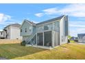 Expansive backyard with a deck, screened in patio and stairs leading to the yard at 736 Mesa Rd, Mcdonough, GA 30253