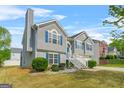 Charming two-story home with blue shutters and a well-maintained front yard at 736 Mesa Rd, Mcdonough, GA 30253