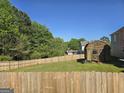Well-maintained backyard features a large shed and a sturdy wooden fence for privacy at 1055 Field View Dr, Mcdonough, GA 30253