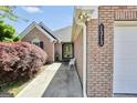 Charming brick home featuring an attached two-car garage, with a cozy entrance area and landscaped walkway at 1313 Jubilee Ln, Mcdonough, GA 30253