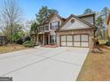 Beautiful two-story home with a large driveway and a well-maintained front yard at 3541 Stoneleigh Walk, Lithonia, GA 30038