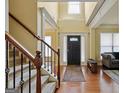 Welcoming foyer featuring hardwood floors, a staircase, and plenty of natural light at 3541 Stoneleigh Walk, Lithonia, GA 30038
