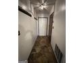 Hallway featuring stone tile flooring, coat rack, decorative light fixture, and access to other rooms at 1499 Carriage Ln, Jonesboro, GA 30238